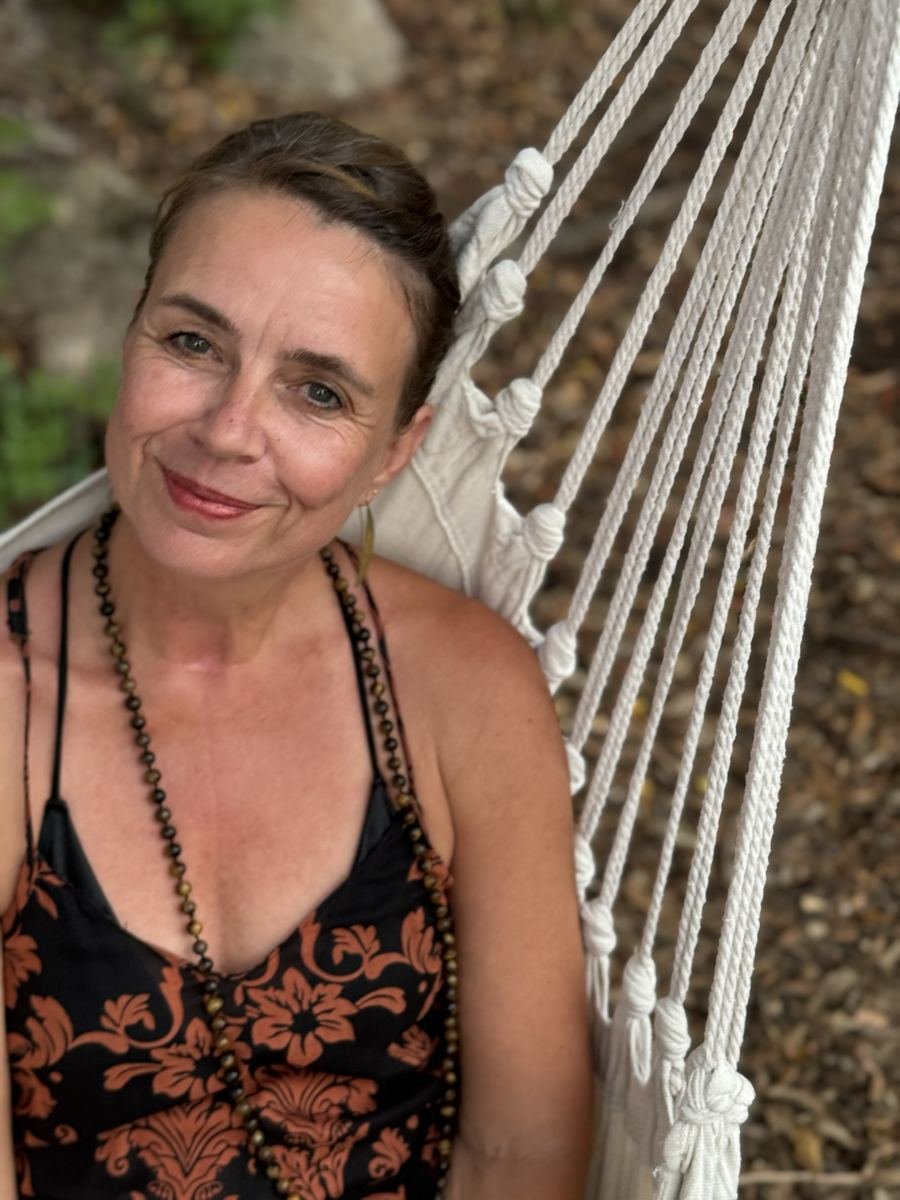 Elke Bayer relaxing in a hammock in a Sardinian garden